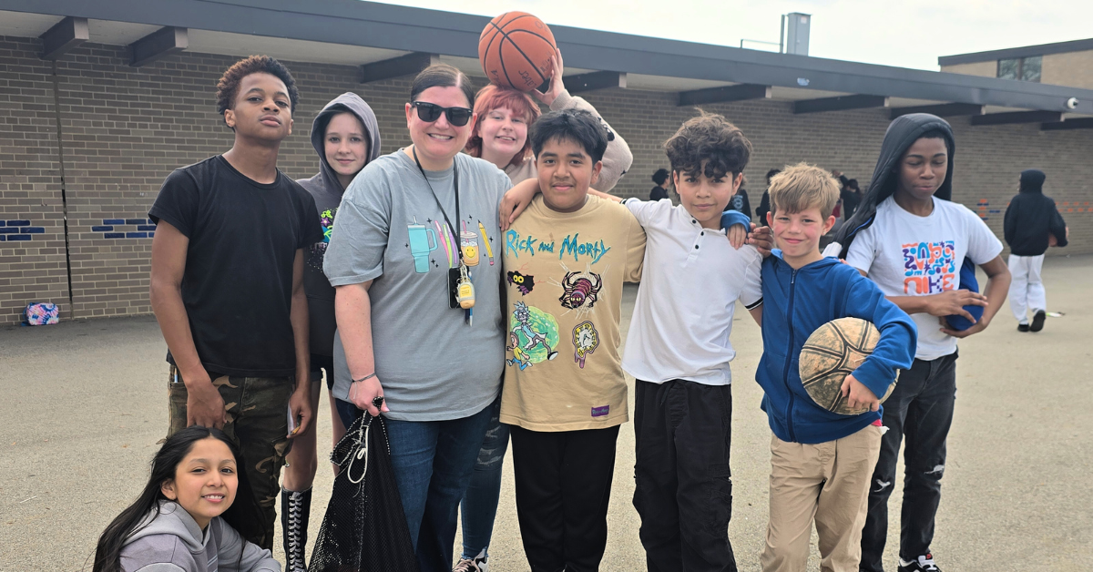 students surrounded by students at recess